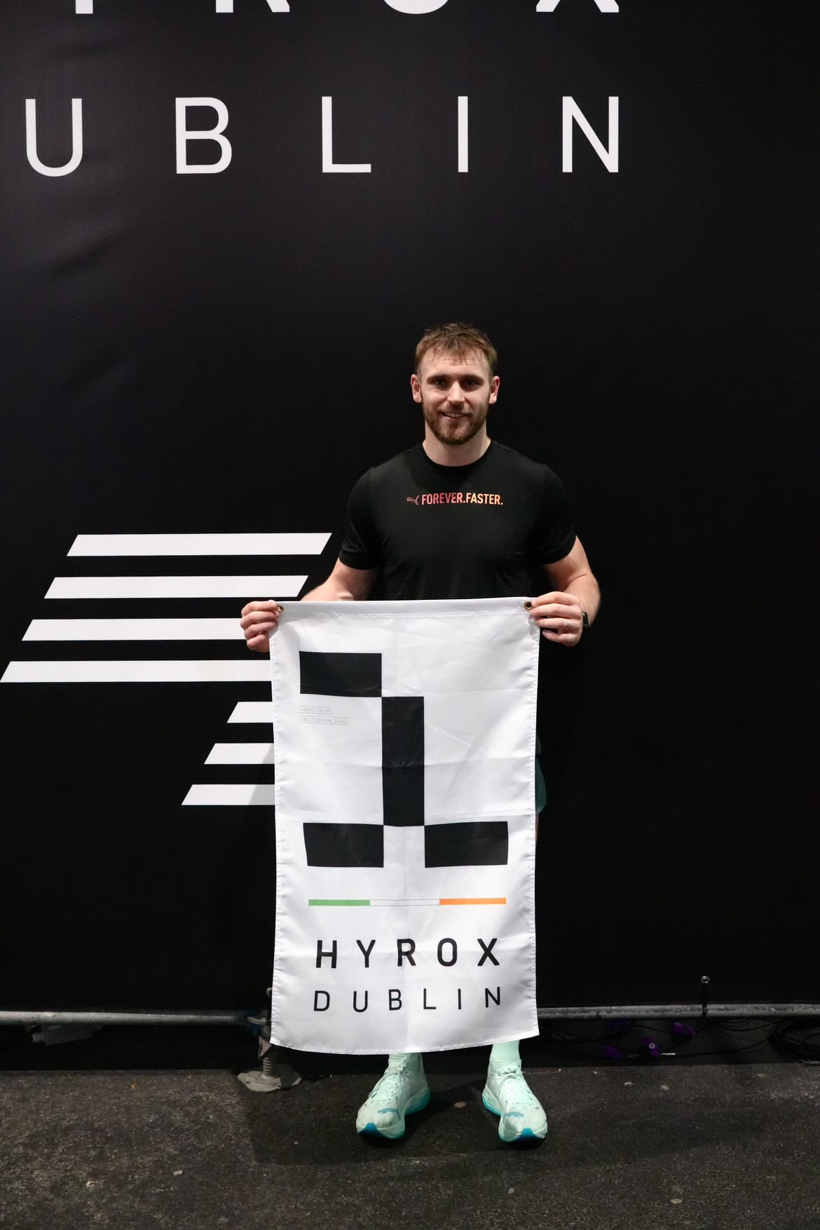 Athlete holding a HYROX Dublin winner's flag